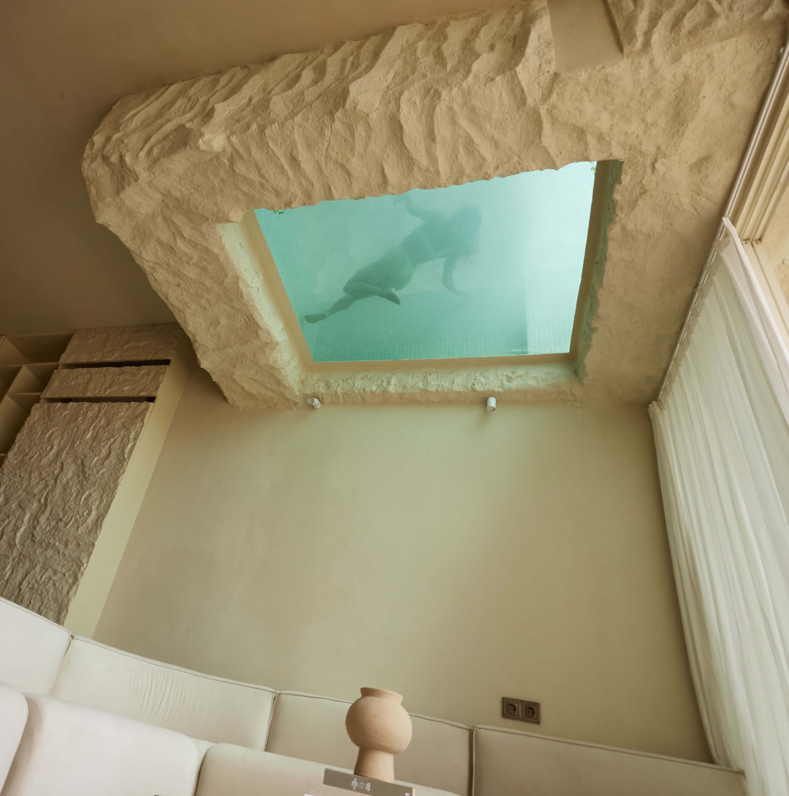 Sculptural sunken lounge inside a FIRA suite