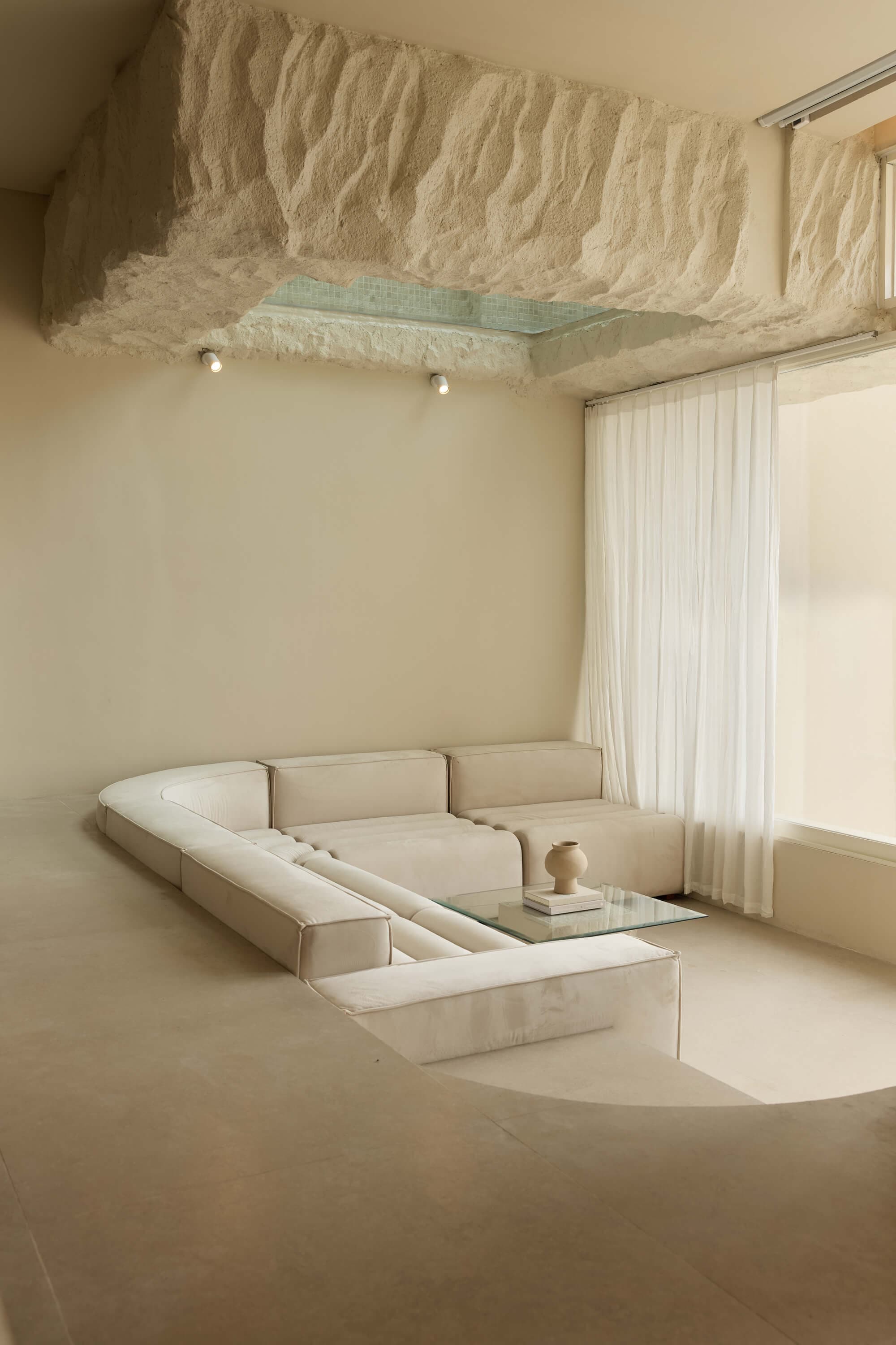 Sculptural sunken lounge inside a FIRA suite